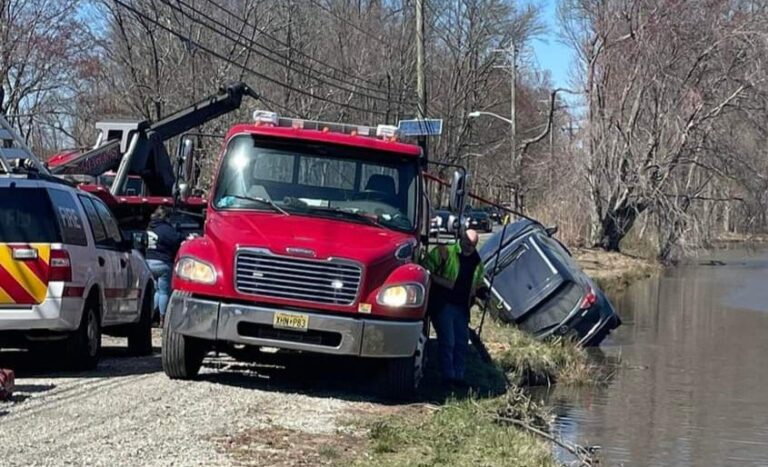 Crews get the car out of the pond and back on land