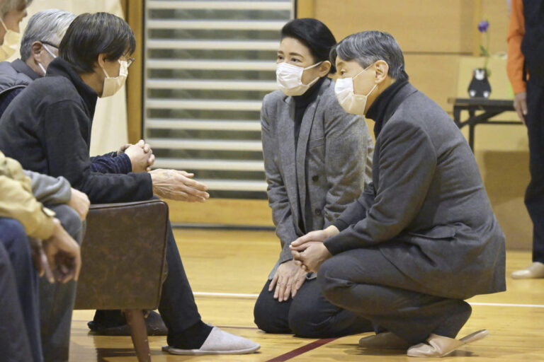 Japanese emperor and empress visit towns hit by Jan. 1 quake and console thousands of homeless