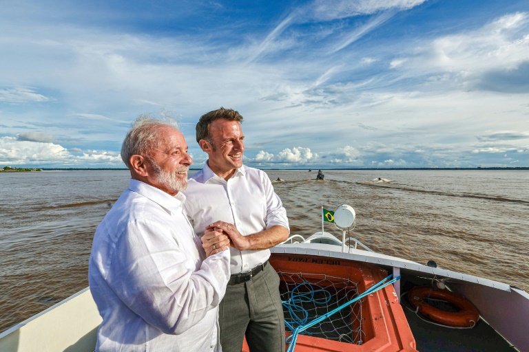 Brazil President Lula and French President Emmanuel Macron hold hands as they share a bilateral meeting while sailing at Guajara Bay off Belem, Brazil, on March 26, 2024 in this handout image from the Brazilian presidency (Ricardo STUCKERT)