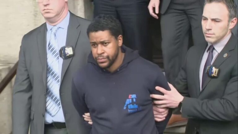 'Perp walk': New Yorkers shout at suspect in fatal shooting of NYPD police officer, who now faces charges