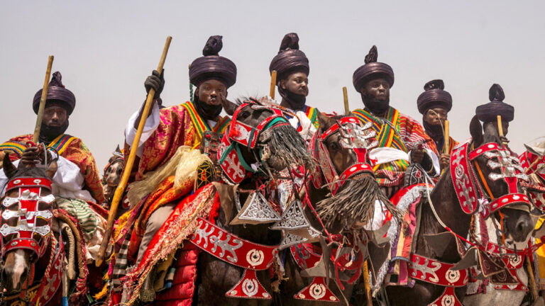 Two Baye Fall members greet each other in Diourbel, Senegal - Friday 5 April 2024