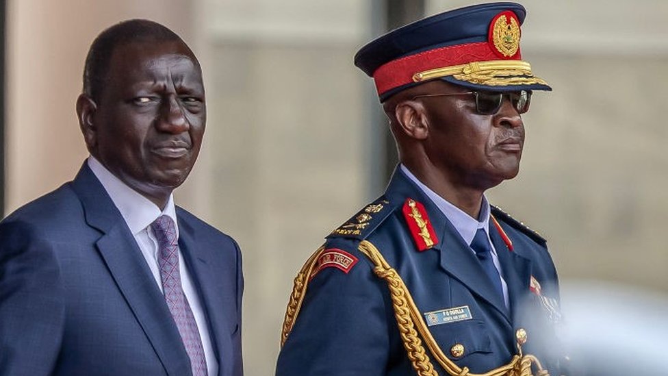 William Ruto (L) and Chief of Kenya Defence Forces General Francis Ogolla (R) look on while inspecting a guard of honour by members of the Kenya Defence Forces (KDF) during his official state visit to State House in Nairobi, on February 28, 2024.