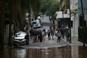 People observe a flooded street at the historical center of Porto Alegre, Rio Grande do Sul state, Brazil (Anselmo Cunha)