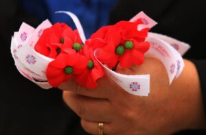 Poppies are handed out during a Memorial Day ceremony in Creswell.