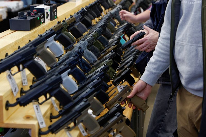 FILE PHOTO: Customers shop at the Des Moines Fairgrounds Gun Show at the Iowa State Fairgrounds in Des Moines, Iowa