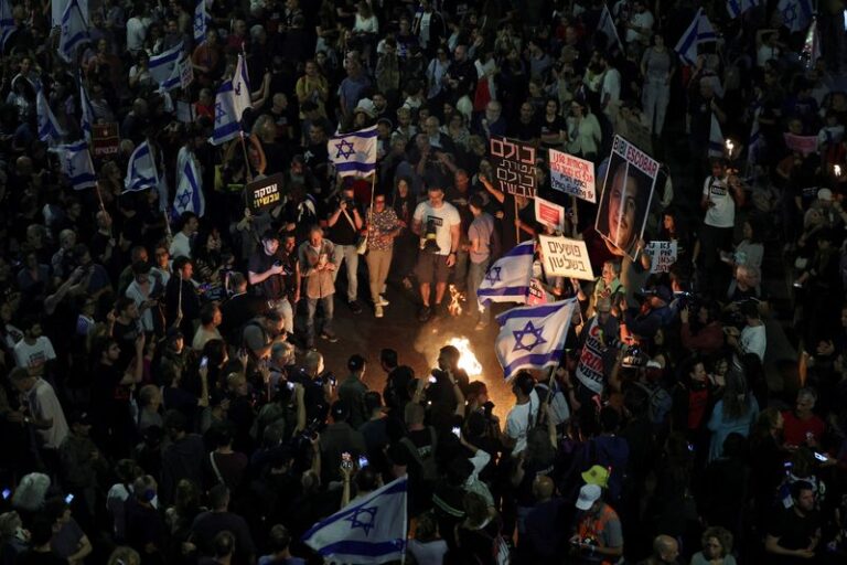 People attend a protest calling for the immediate release of hostages, in Tel Aviv