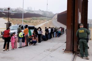 FILE PHOTO: Asylum-seekers at border walls between the U.S. and Mexico