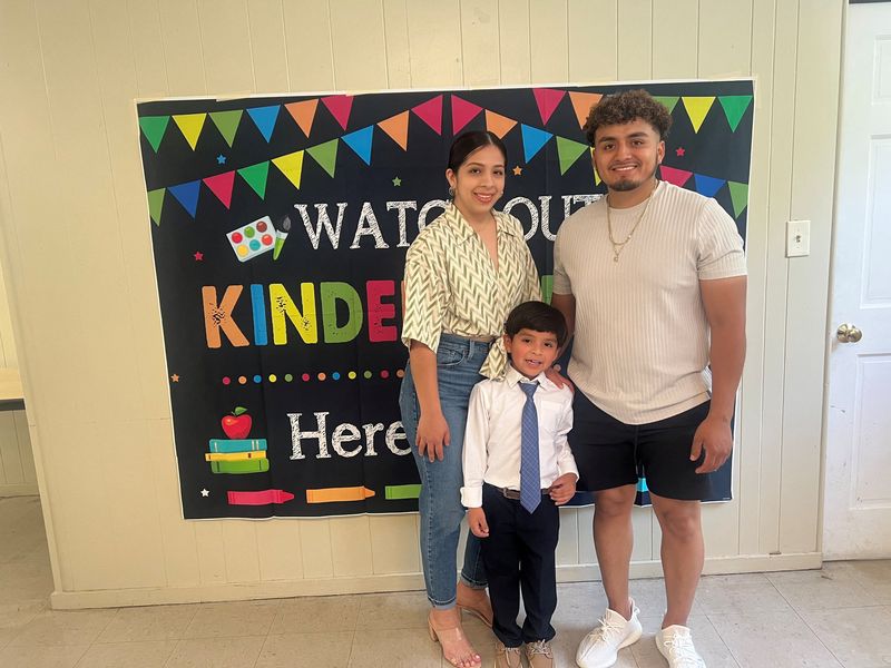 Genaro Vicencio, an immigrant from Mexico, poses for a picture with his American wife Cindy Maduena and their son Israel