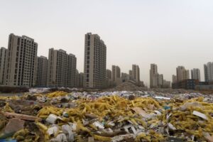FILE PHOTO: Debris is seen in front of the apartment compound Taoyuan Xindu Kongquecheng developed by China Fortune Land Development, in Zhuozhou