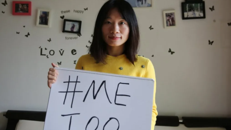 Sophia Huang Xueqin holds a sign reading MeToo