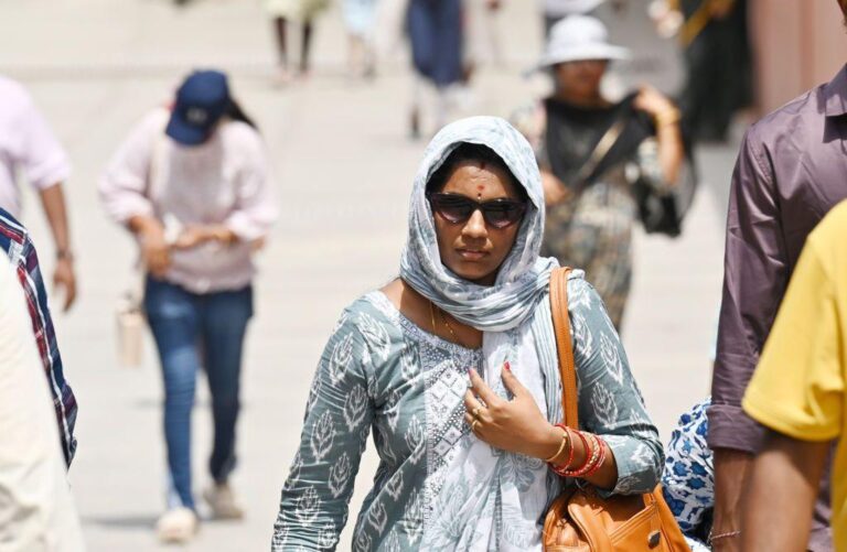  Visitors brave the heat Wave during a hot summer afternoon at Kartavya Path Lawns, on June 4, 2024 in New Delhi, India. 